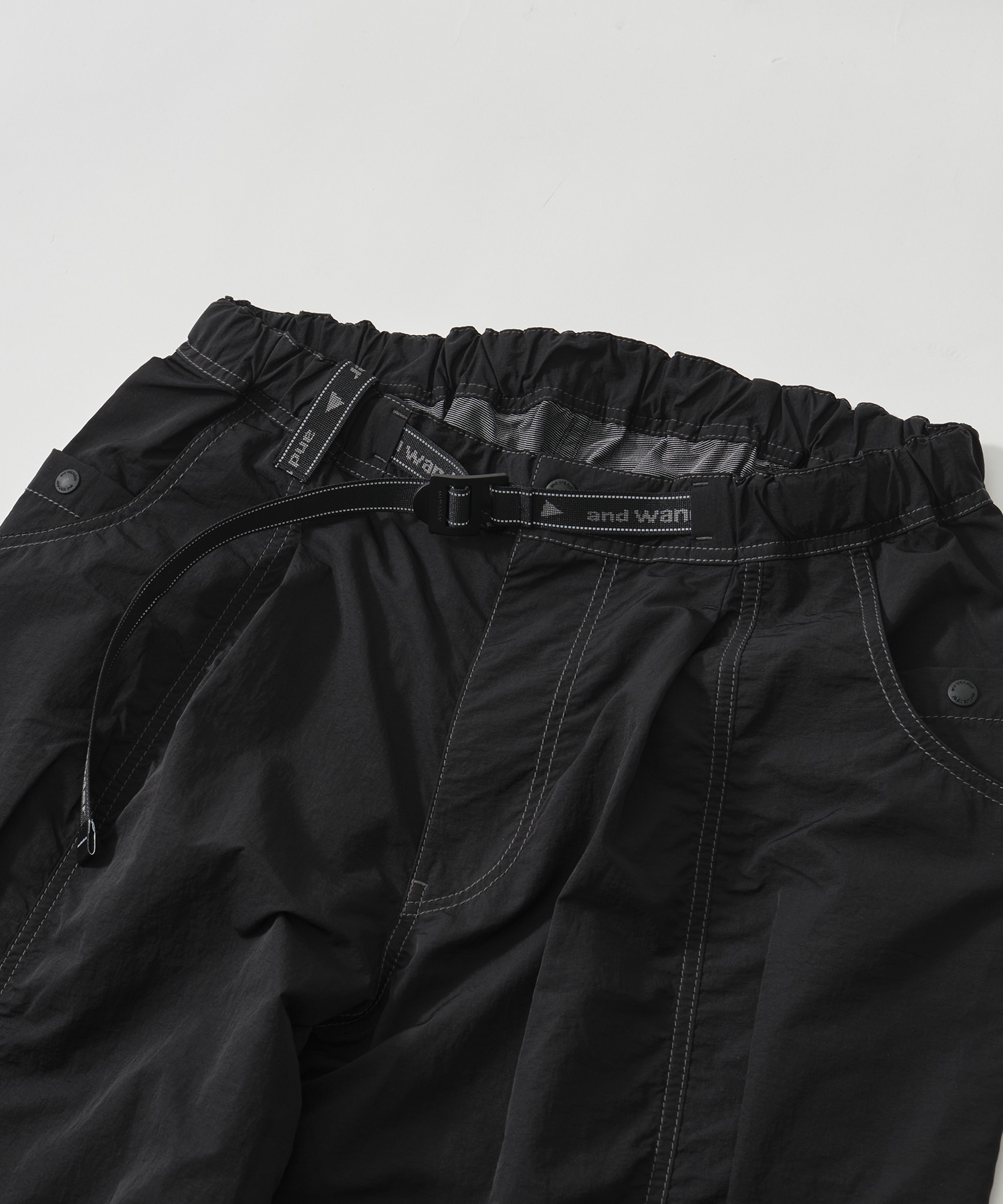 crinkled nylon pants and wander