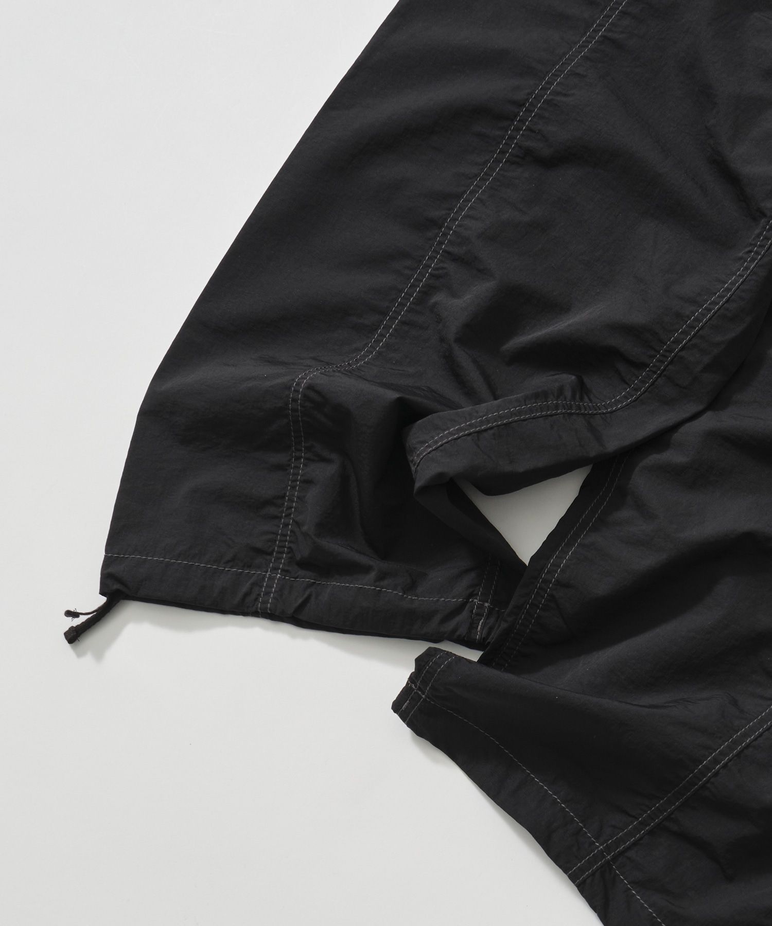 crinkled nylon pants and wander