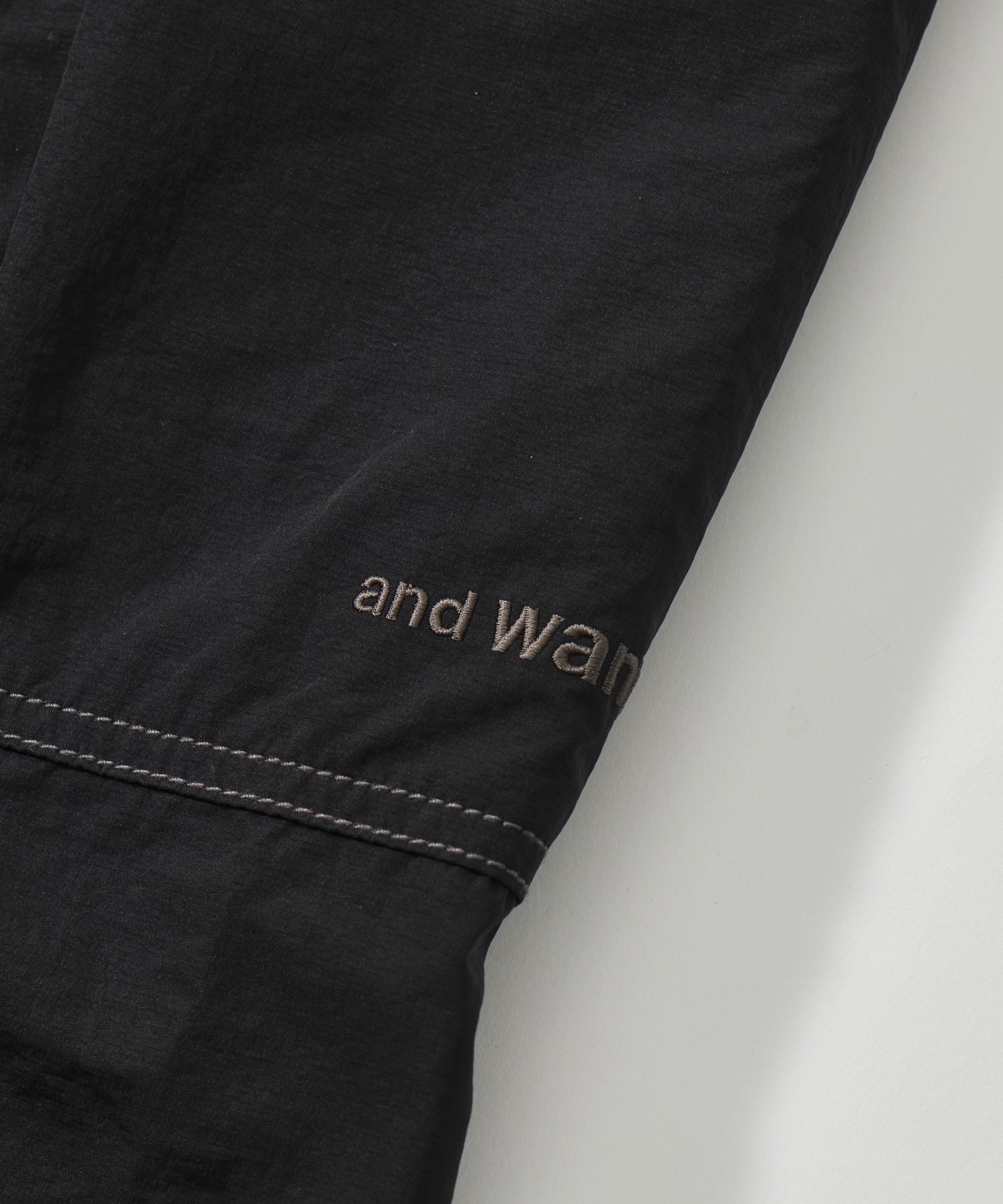 crinkled nylon pants and wander