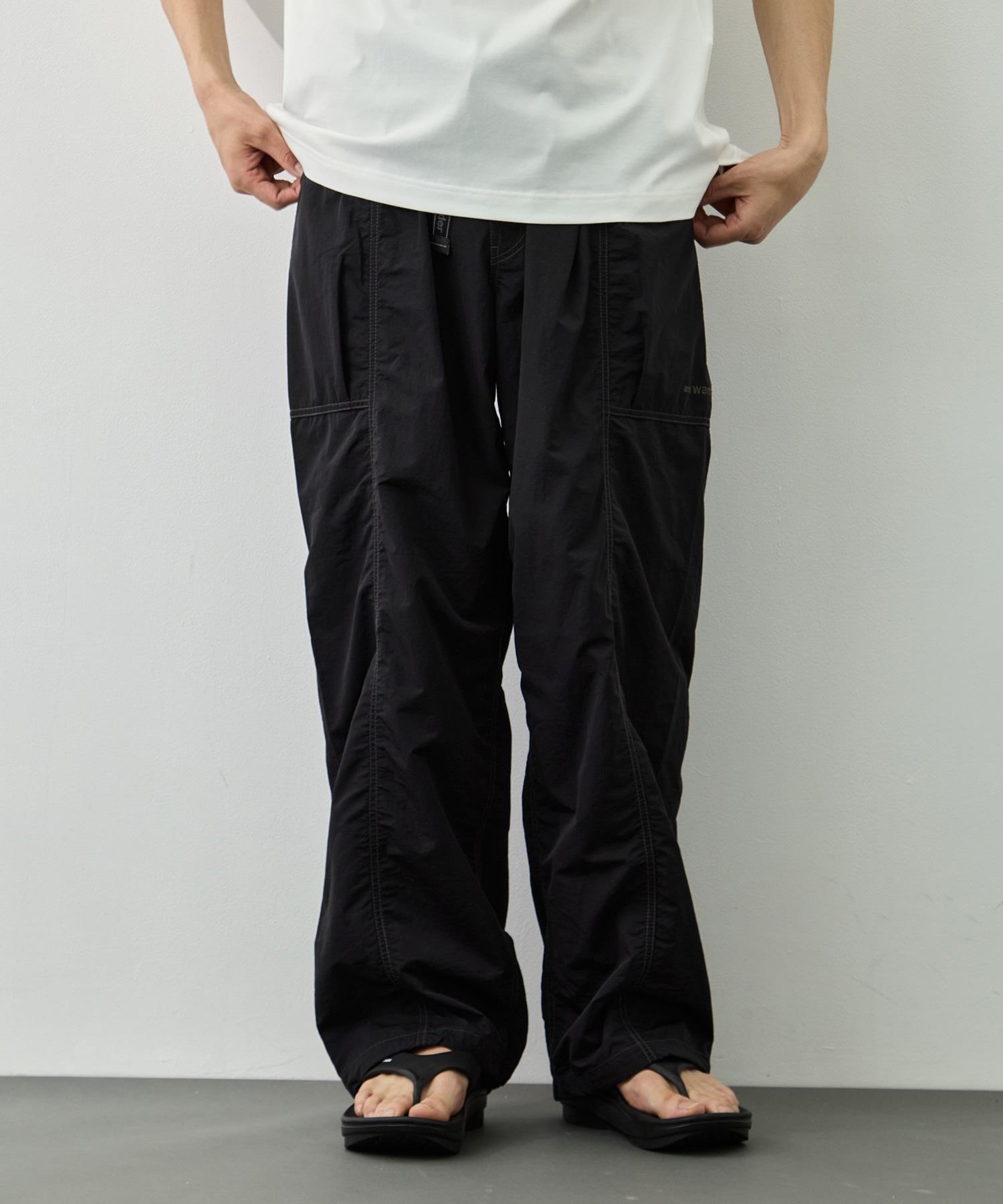 crinkled nylon pants and wander