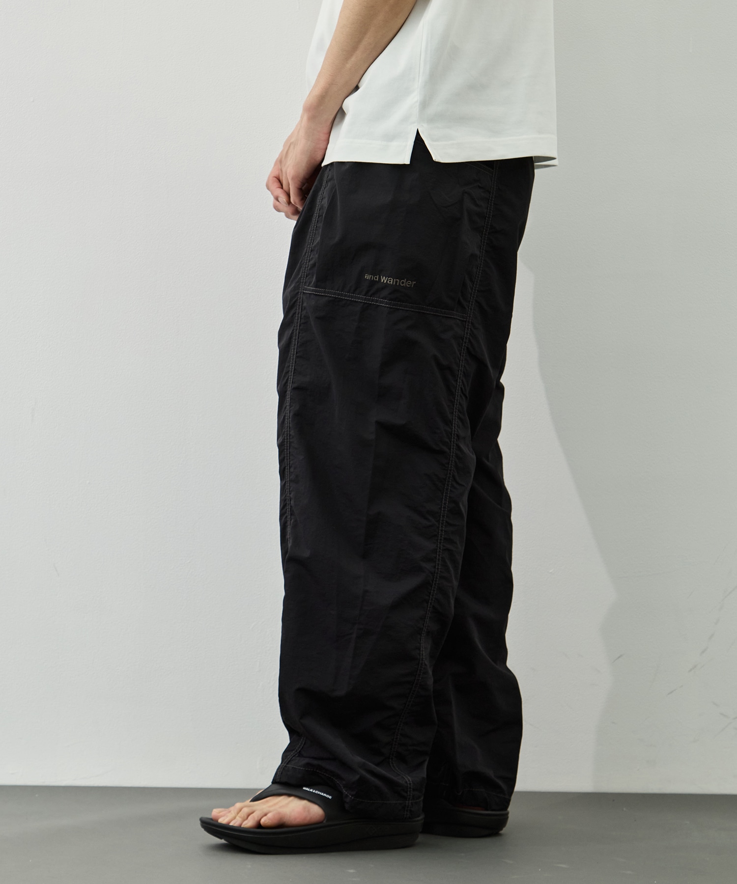 crinkled nylon pants and wander