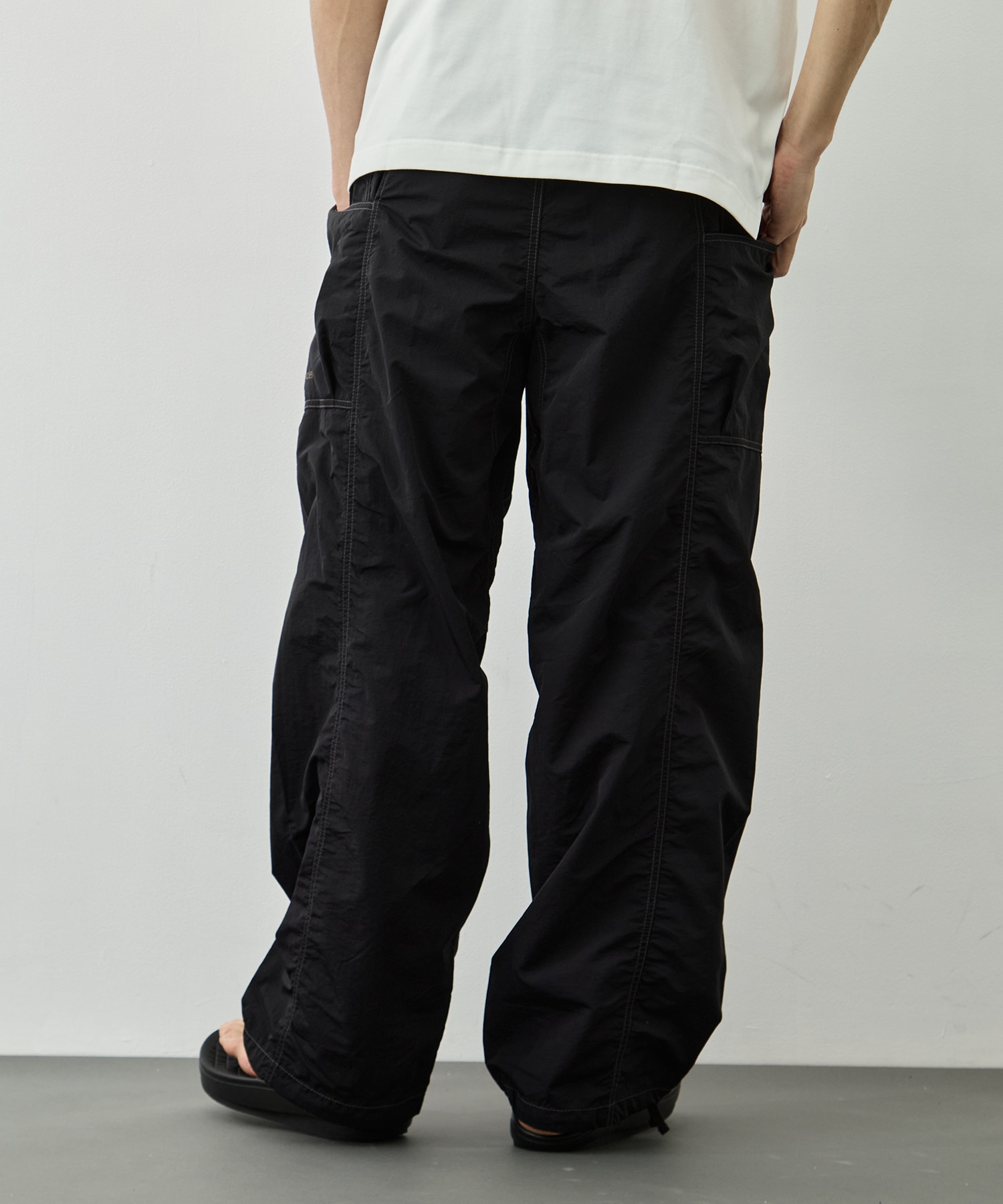 crinkled nylon pants and wander